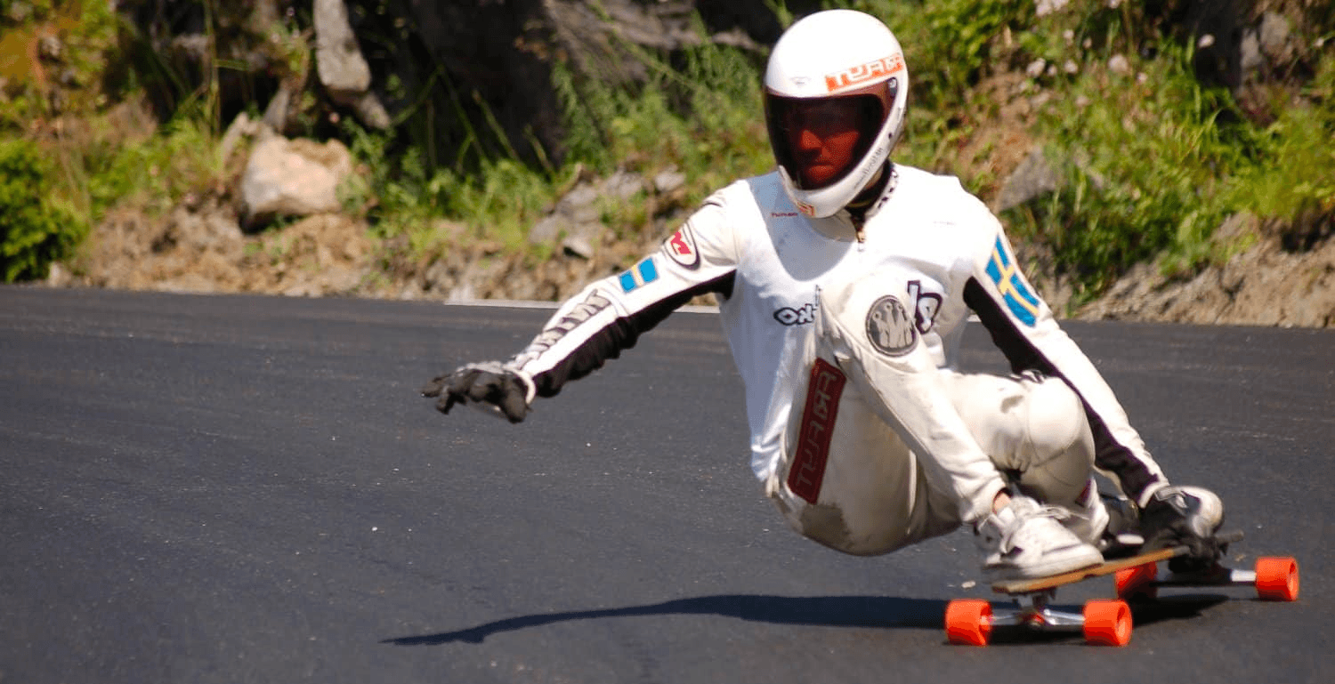 downhill longboarder leaning into a turn